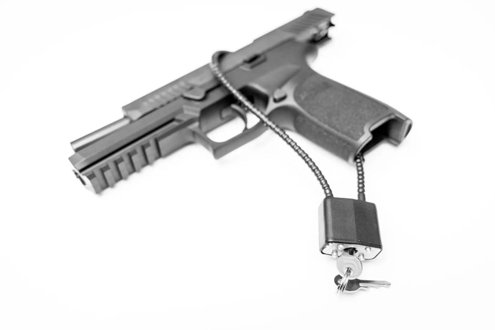 Locked disarmed and secured handgun on isolated white background